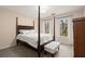 Bright bedroom featuring natural light, four poster bed, and white ottoman at 203 Northside Nw Dr, Kennesaw, GA 30144