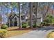 Traditional two-story home with a white brick exterior, dark trim, and mature landscaping at 203 Northside Nw Dr, Kennesaw, GA 30144