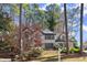 Charming two-story home with grey brick, dark trim, and mature trees in a wooded setting at 203 Northside Nw Dr, Kennesaw, GA 30144