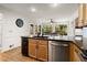 Kitchen island featuring a black countertop, wooden cabinets, and stainless steel appliances at 203 Northside Nw Dr, Kennesaw, GA 30144