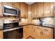 Close-up of a kitchen with granite countertops, stainless steel appliances, and light wood cabinetry at 203 Northside Nw Dr, Kennesaw, GA 30144