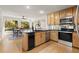 Bright eat-in kitchen with stainless steel appliances, black countertops, and a view of the lush backyard at 203 Northside Nw Dr, Kennesaw, GA 30144