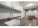Spacious kitchen featuring granite countertops, a farmhouse sink, and views of the living spaces at 203 Northside Nw Dr, Kennesaw, GA 30144