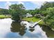 Aerial view of the lake with a gazebo, reflecting peaceful waterfront living and the community's natural beauty at 203 Northside Nw Dr, Kennesaw, GA 30144
