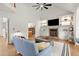 Spacious living room with hardwood floors, fireplace, and built-in shelving, perfect for gatherings and relaxation at 203 Northside Nw Dr, Kennesaw, GA 30144