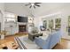 Bright living room with vaulted ceiling, fireplace, built-ins, and large windows offering scenic views at 203 Northside Nw Dr, Kennesaw, GA 30144