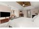 Main bedroom boasts tray ceilings, ceiling fan, sitting area, and a large-screen TV at 203 Northside Nw Dr, Kennesaw, GA 30144