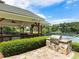 Outdoor grill area featuring a stone surround, stainless steel grill, and ample seating for outdoor cooking and entertaining at 203 Northside Nw Dr, Kennesaw, GA 30144