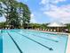 Large swimming pool surrounded by lounge chairs and covered seating areas offers a perfect spot for summer relaxation at 203 Northside Nw Dr, Kennesaw, GA 30144