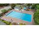 Aerial view of a large community pool with lounge chairs and umbrellas, perfect for relaxation and recreation at 203 Northside Nw Dr, Kennesaw, GA 30144