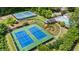 Aerial view of the community tennis courts featuring pristine blue courts and lush green landscaping surrounding the area at 203 Northside Nw Dr, Kennesaw, GA 30144