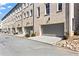 Row of brick townhomes with gray garages and landscaped front yards on a sunny day at 3475 Landen Pine Ne Ct, Atlanta, GA 30305