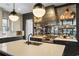 Modern kitchen with stainless appliances, dark cabinets, light countertops, and mirrored backsplash at 3475 Landen Pine Ne Ct, Atlanta, GA 30305
