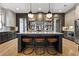 Modern kitchen features pendant lights, a large island with seating, and mirrored backsplash detail at 3475 Landen Pine Ne Ct, Atlanta, GA 30305