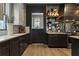 Updated kitchen featuring dark cabinetry, stone countertops, and stainless steel appliances at 3475 Landen Pine Ne Ct, Atlanta, GA 30305