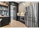 Modern kitchen with stainless appliances, dark cabinets, light countertops, and stainless steel refrigerator at 3475 Landen Pine Ne Ct, Atlanta, GA 30305