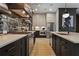 Modern kitchen with stainless appliances, dark cabinets, light countertops, and a mirrored backsplash at 3475 Landen Pine Ne Ct, Atlanta, GA 30305