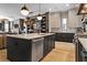 Open-concept kitchen features an eat-in island and opens to the living area at 3475 Landen Pine Ne Ct, Atlanta, GA 30305