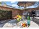 Close up of stylish patio furniture featuring flowers, shade umbrella, and privacy wall at 3475 Landen Pine Ne Ct, Atlanta, GA 30305