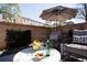 Relaxing outdoor patio with comfortable seating, an umbrella, and a view of greenery at 3475 Landen Pine Ne Ct, Atlanta, GA 30305