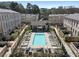 Aerial view of a community pool surrounded by lounge chairs and modern residential buildings at 3475 Landen Pine Ne Ct, Atlanta, GA 30305