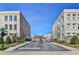 Community entrance showcases well-maintained townhomes and landscaping, with controlled access at 3475 Landen Pine Ne Ct, Atlanta, GA 30305