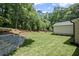 Spacious, green backyard featuring a retaining wall and established landscaping at 372 Karen Dr, Alpharetta, GA 30009