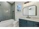 Stylish bathroom with herringbone tile shower, marble vanity and modern fixtures at 372 Karen Dr, Alpharetta, GA 30009