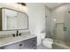 Modern bathroom featuring a marble vanity, and a sleek glass-enclosed shower at 372 Karen Dr, Alpharetta, GA 30009