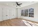Bright bedroom with ample light, hardwood floors, ceiling fan, and closet space at 372 Karen Dr, Alpharetta, GA 30009