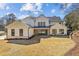 Exterior back view of a two-story white home with black trim and a large backyard at 372 Karen Dr, Alpharetta, GA 30009