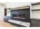 Modern fireplace with elegant stone surround flanked by custom built-ins at 372 Karen Dr, Alpharetta, GA 30009