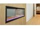 Modern fireplace encased in tan tile with stylish purple and gold accents at 372 Karen Dr, Alpharetta, GA 30009