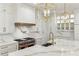 Gourmet kitchen boasts marble countertops, stainless steel range, pot filler, and custom white cabinetry at 372 Karen Dr, Alpharetta, GA 30009