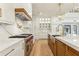 Kitchen featuring stainless steel appliances, white cabinetry, marble countertops, and gold hardware accents at 372 Karen Dr, Alpharetta, GA 30009