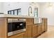 Wooden kitchen island with a stainless steel microwave, sink, storage cabinets, and marble countertop at 372 Karen Dr, Alpharetta, GA 30009