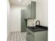 Functional laundry room with ample cabinet storage and stylish patterned flooring at 372 Karen Dr, Alpharetta, GA 30009