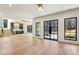 Bright living room with wood floors, staircase, modern doors, and open access to kitchen at 372 Karen Dr, Alpharetta, GA 30009