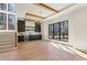 Bright living room with large windows, wooden floors, bar area, and wooden staircase at 372 Karen Dr, Alpharetta, GA 30009