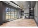 Modern living room with a fireplace, built-in shelves, large windows, wooden floors, and modern chandelier at 372 Karen Dr, Alpharetta, GA 30009