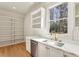 Pantry includes a sink, dishwasher, white cabinets, marble countertops, and window with a scenic view at 372 Karen Dr, Alpharetta, GA 30009