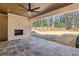 Inviting covered patio with stone floor, fireplace and ceiling fan provides an ideal outdoor living space at 372 Karen Dr, Alpharetta, GA 30009