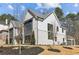 Side view of a house with a brick and siding exterior, landscaping, and a three-car garage at 372 Karen Dr, Alpharetta, GA 30009