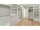 Spacious walk-in closet with white built-in shelving, drawers, and plenty of hanging space at 372 Karen Dr, Alpharetta, GA 30009