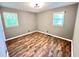 Well-lit bedroom with clean lines, featuring laminate flooring and two windows bringing in natural light at 812 Amber Place Nw, Atlanta, GA 30331