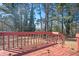 Inviting back deck offers a serene outdoor space surrounded by lush trees and natural beauty at 1887 King Charles Sw Rd, Atlanta, GA 30331