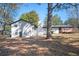 Home's backyard featuring mature trees and a deck perfect for outdoor enjoyment at 1887 King Charles Sw Rd, Atlanta, GA 30331