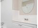 A bright bathroom features a tub with shower and white vanity with decorative mirror at 1887 King Charles Sw Rd, Atlanta, GA 30331