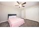 This bedroom features carpet, a ceiling fan, and a double closet for storage at 1887 King Charles Sw Rd, Atlanta, GA 30331