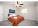 A bedroom with carpet, ceiling fan, and a window creates a tranquil space for relaxation at 1887 King Charles Sw Rd, Atlanta, GA 30331